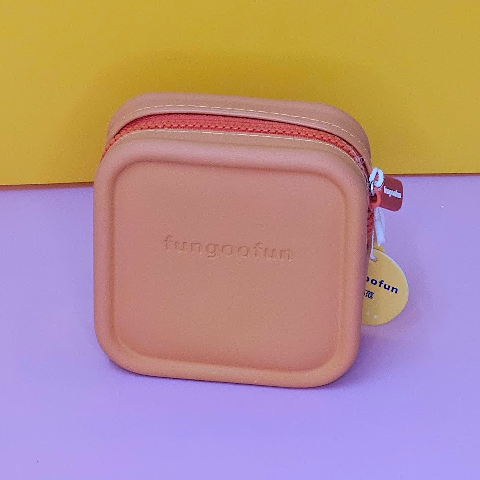 Pink square pouch with zipper on a purple and yellow background
